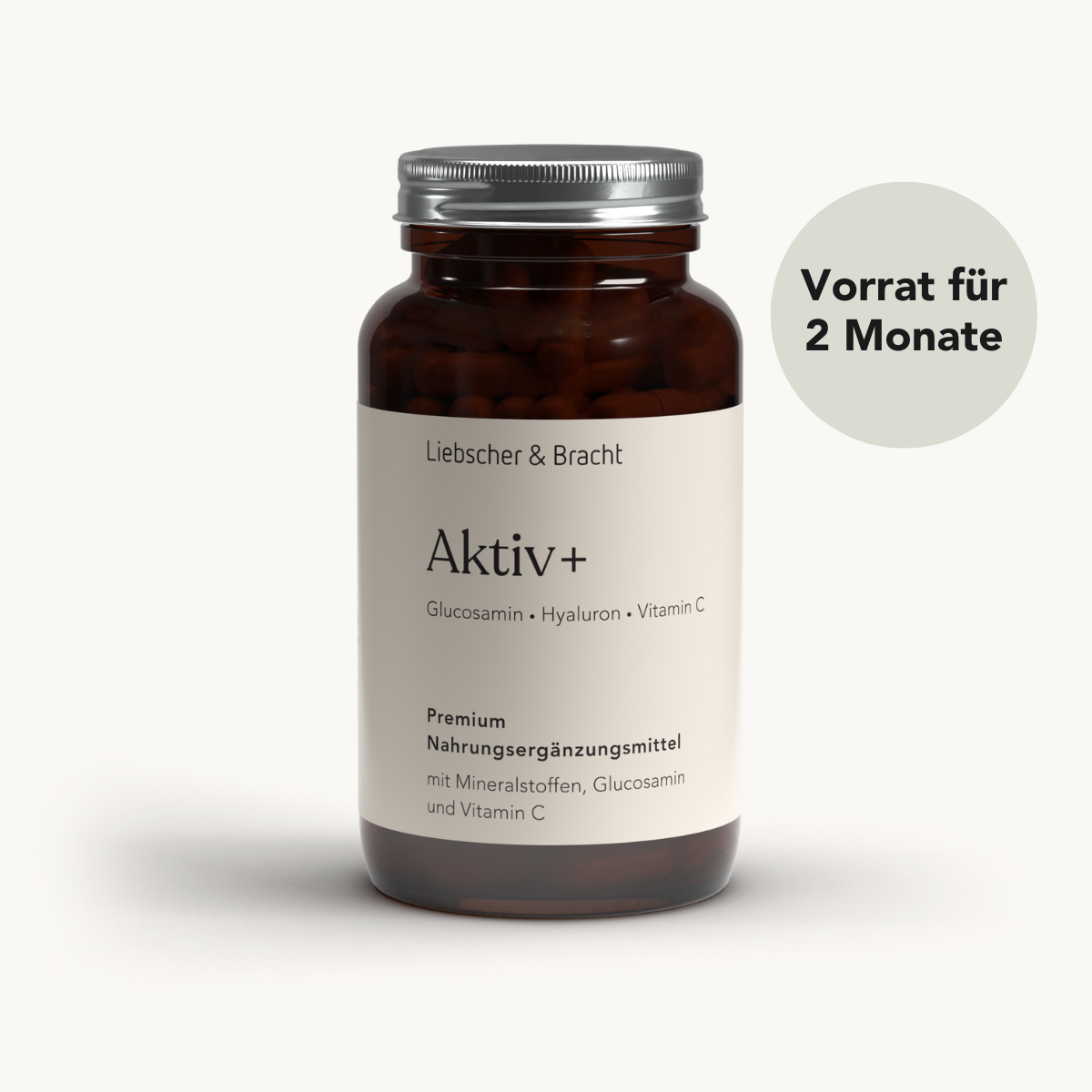 Eine braune Glasflasche mit der Aufschrift Liebscher & Bracht Aktiv+ für 2 Monate, ein hochwertiges Nahrungsergänzungsmittel mit Mineralien, Glucosamin, Vitamin C, Kupfer und Mangan. Ein grüner Kreis vermerkt: Vorrat für 2 Monate.