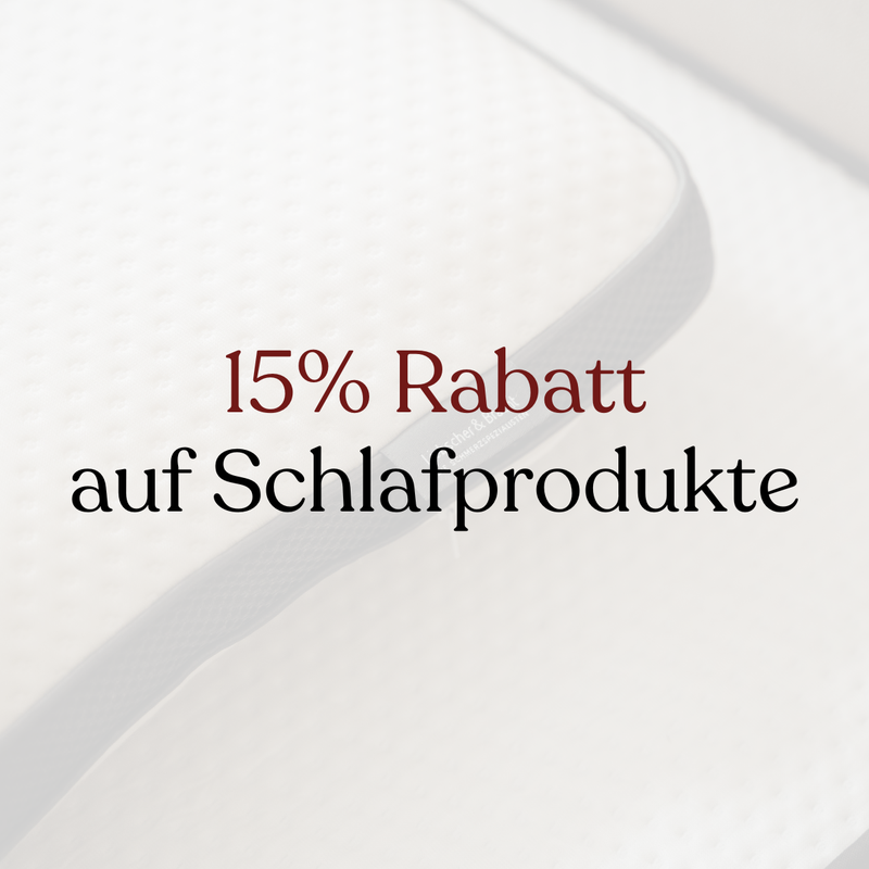 Der Text 15% Rabatt auf Schlafprodukte steht mittig über einer Nahaufnahme einer weißen Matratze mit strukturierter Oberfläche und grauem Rand.