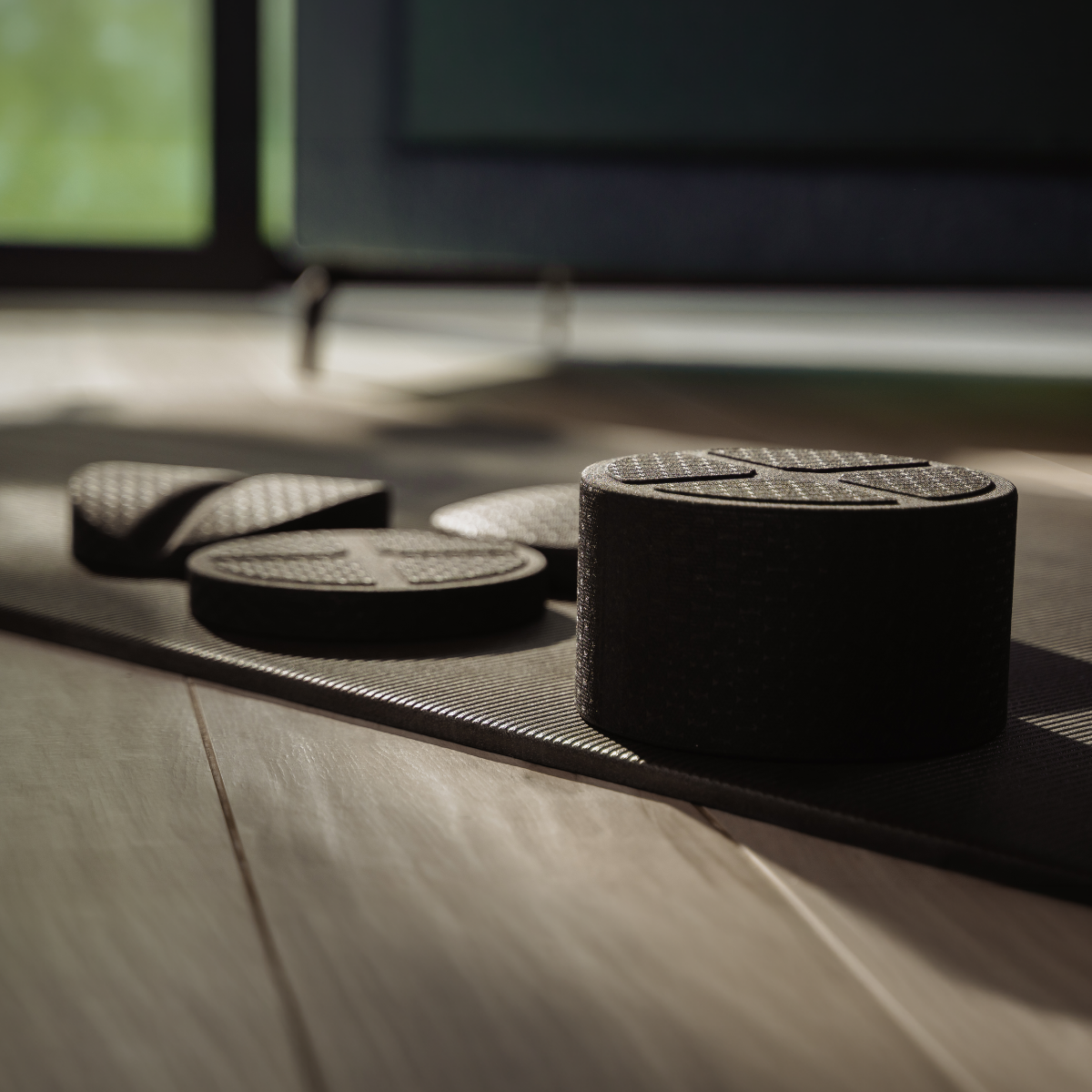 Der Rückenretter von Liebscher & Bracht: Schwarze Balance-Pods und strukturierte Pads auf einer Yogamatte – ideal für Übungen bei Rückenbeschwerden und zur Verbesserung der Körperhaltung.